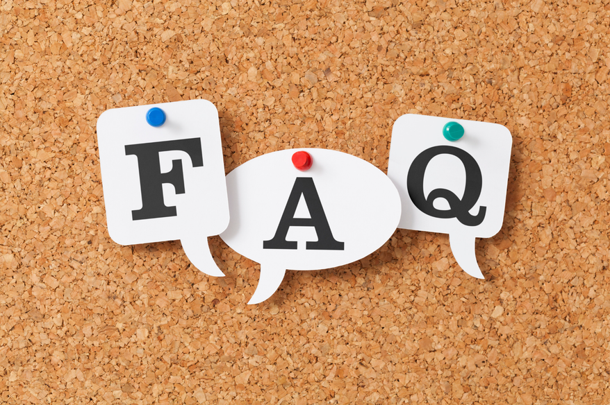 Three speech-bubble cutouts pinned to a corkboard, spelling out F A Q.